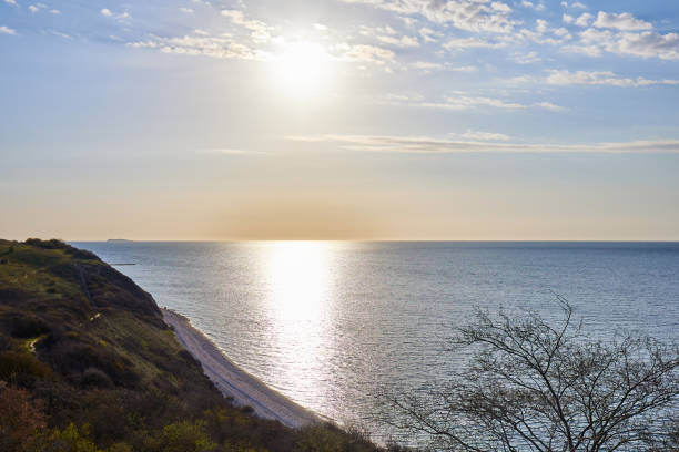 Scenic tranquil view of beautiful seascape with bright sun in sky over horizon during sunny day at Denmark