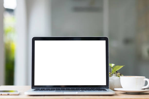 istock Mockup of laptop computer with empty screen with coffee cup and smartphone on table of the coffee shop background,White screen 2147620118