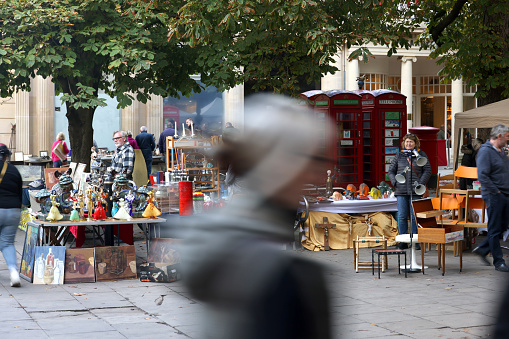 Busy flea market selling antiques and Bric-à-brac in the centre of the Cotswold town of Cheltenham