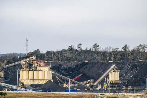 Gothenburg, Sweden - February 20 2024: Stone quarry machinery crossing and sorting rock.
