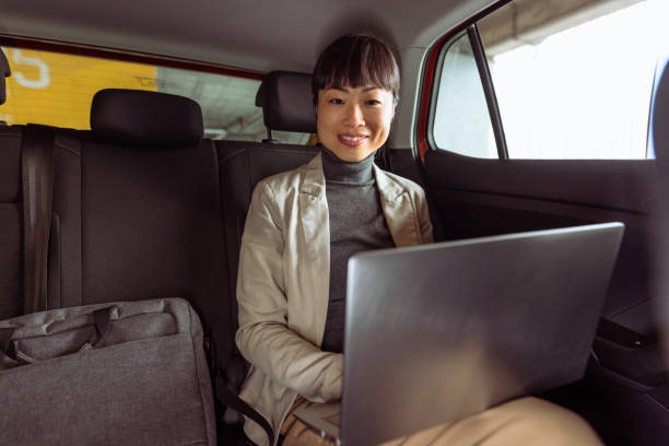 istock An Asian businesswoman using a laptop during a car ride 2147624636