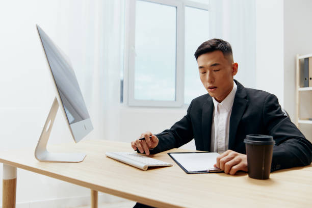 istock businessmen sitting at a desk in front of a computer emotions technologies 2147625243