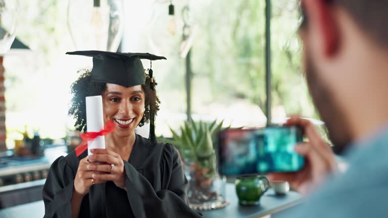 Graduation, photograph and student friends hugging in home with phone for celebration or memory. Education, face and smile with people hugging for university achievement or college success together