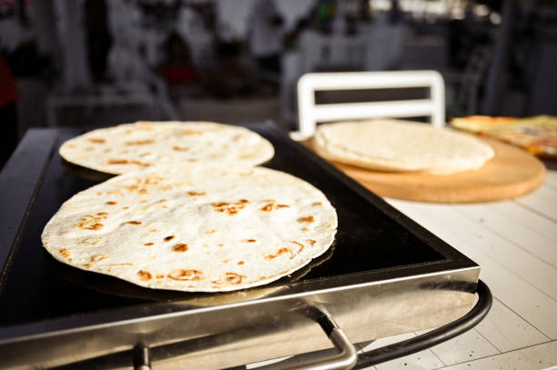 Close up of a flatbread on cooking pan.
