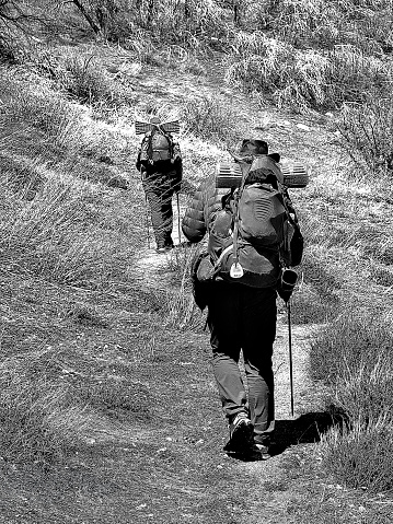 Riverside, California/USA - March 29th 2024: Two people attempt to hike over 2,650 miles from the Mexican border to Canada, the Pacific Crest Trail winds through some of North America's most breathtaking landscapes, including deserts, forests, and mountain ranges. The two hikers are on this transformative journey, both physically and mentally, as they traverse diverse terrain, encountering wildlife and forging connections with fellow hikers along the way. From the sun-drenched valleys of California to the snow-capped peaks of the Cascades, the PCT beckons those seeking solitude, challenge, and the unparalleled beauty of the wilderness.