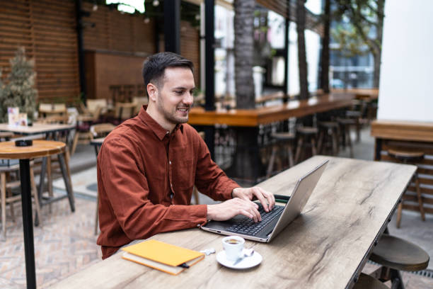 istock Smiling young man working on laptop 2147629969