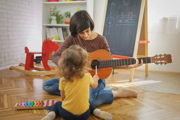 istock Mother and child playing with music instruments at home 2147631480