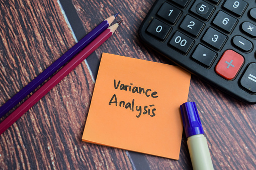 Concept of Variance Analysis write on sticky notes isolated on Wooden Table.