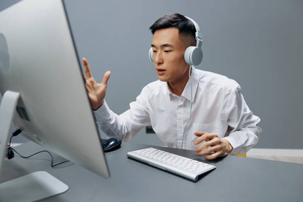 istock Asian man computer with keyboard on desk in office internet Gray background 2147633496