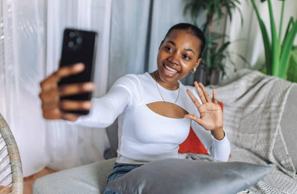 istock Young black woman enjoying a virtual conversation at home 2147634507