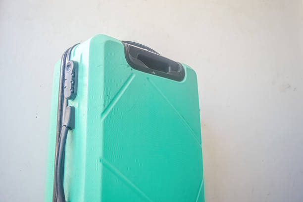 a turquoise green suitcase isolated on white background