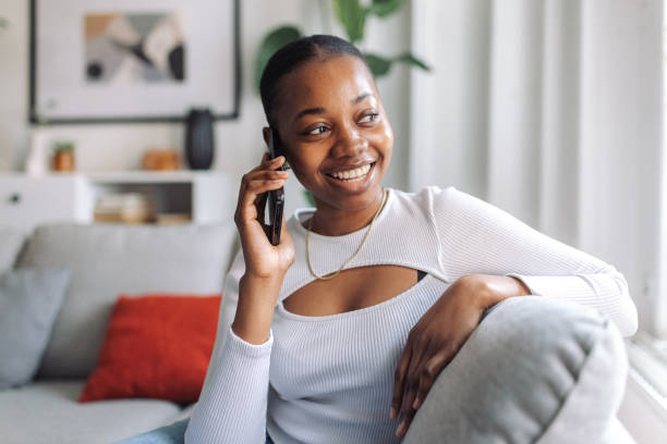 istock Radiant woman enjoying phone conversation at home 2147635678