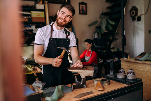 Team of young cobblers Young coblers working in their workshop shoe mold stock pictures, royalty-free photos & images