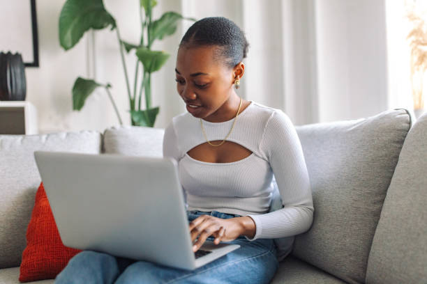 istock Young black woman working on laptop at home 2147635920