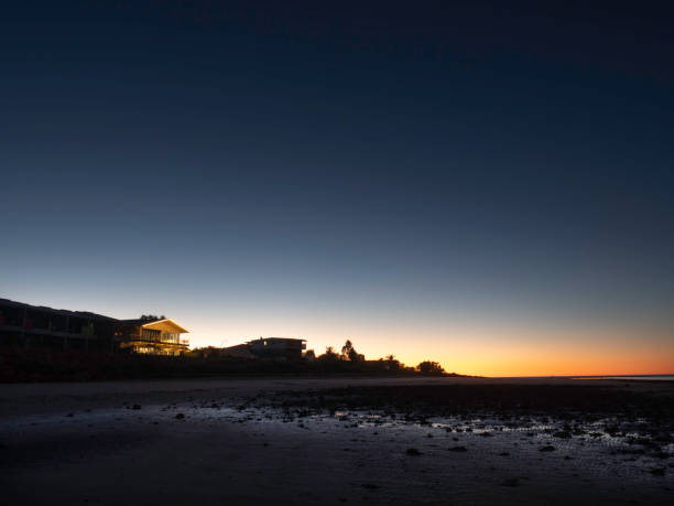 Illuminated house at night on beach,  Onslow Western Australia
