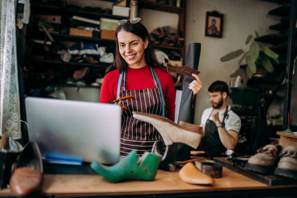 istock Female cobbler working on a laptop 2147637014