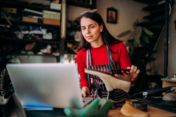istock Female cobbler working on a laptop 2147637562