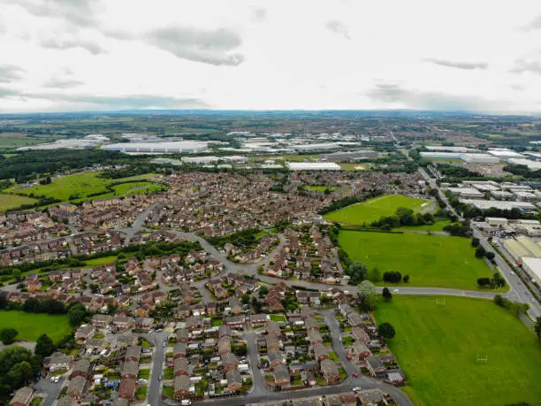 Aerial photo of a housing estate in the village of Castleford, Wakefield in West Yorkshire in the UK showing rows of newly built houses in the village in the summer time.