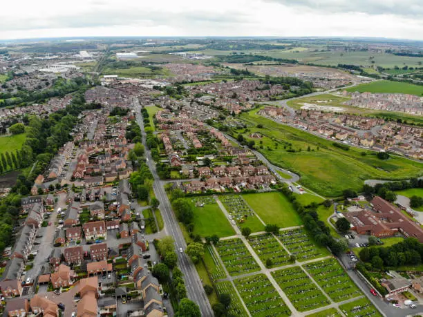 Aerial photo of a housing estate in the village of Castleford, Wakefield in West Yorkshire in the UK showing rows of newly built houses in the village in the summer time.