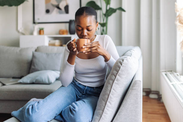 istock Serene woman enjoying coffee at home 2147639619