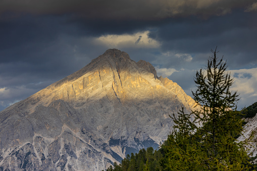 Dolomites mountains, Alpi Dolomiti beautiful scenic landscape in summer. Italian Alps mountain summits and rocky peaks above green valley alpine scene