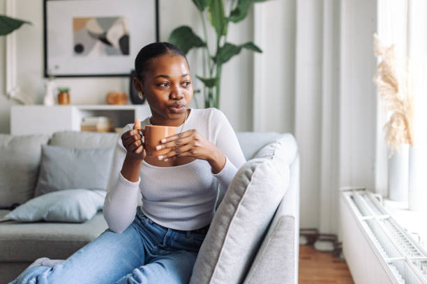 istock Serene morning: black woman enjoying coffee at home 2147639715