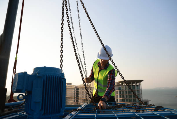 istock An engineer works with a hoist to perform maintenance on the HVAC system and chiller on the rooftop of a building. 2147639870