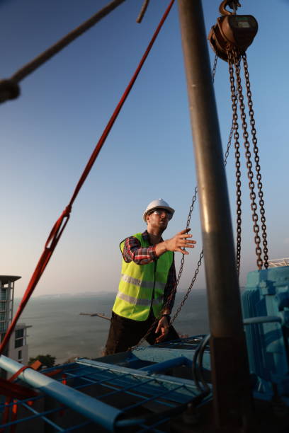 istock An engineer works with a hoist to perform maintenance on the HVAC system and chiller on the rooftop of a building. 2147639878