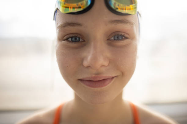 Portrait of a girl in swimwear after swimming practice indoors.