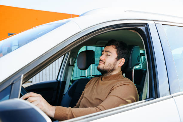 istock a quiet young driver is in his car, in traffic. bearded man calm, thoughtful, 2147640541