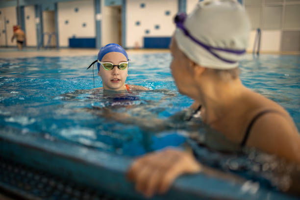 istock Girl and grandma swimmers taking a break 2147641419