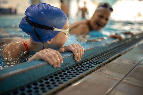 istock Girl and grandma swimmers taking a break 2147641424