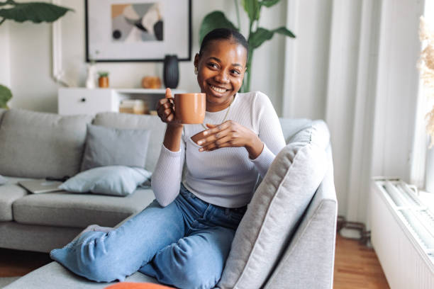 istock Smiling woman enjoying coffee at home 2147641450