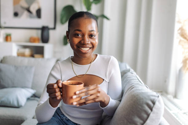 istock Smiling woman enjoying coffee at home 2147641707