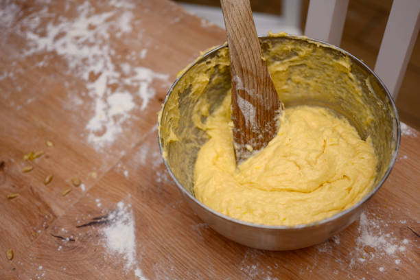Mom and child kneading dough together, hands visible