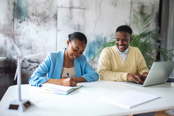 istock Colleagues discussing renewable energy in office 2147642490