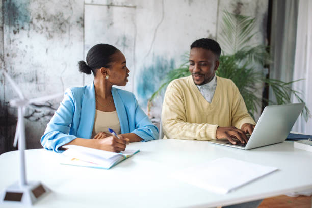 istock Colleagues discussing renewable energy in office 2147642515