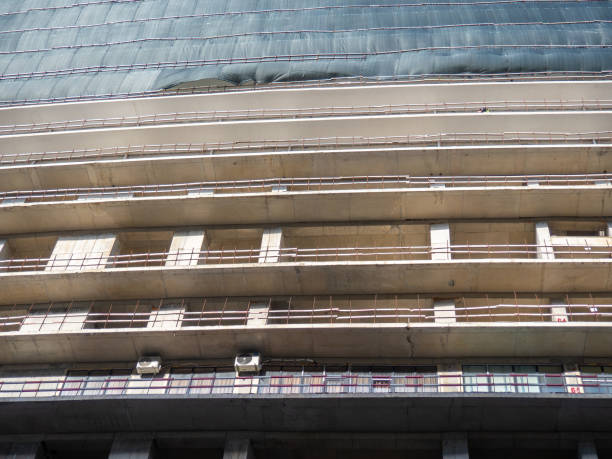 Concrete frame without facade. Unfinished construction of a multi-story building. Modern construction
