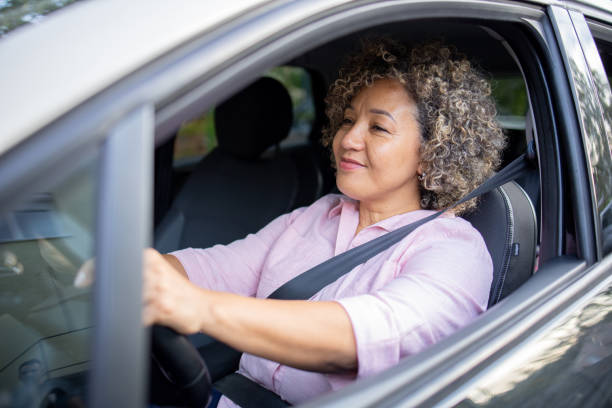 istock Woman is driving a car on her way to work 2147647442