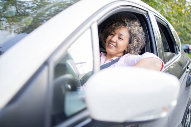 istock Woman is driving a car on her way to work 2147647443