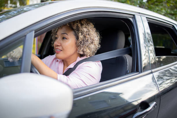 istock Woman is driving a car on her way to work 2147647444