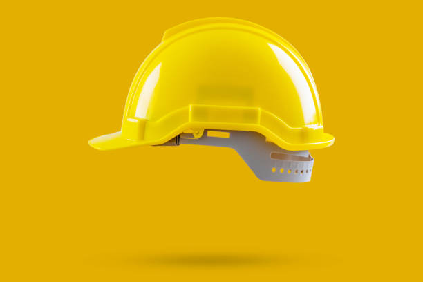 istock Safety construction helmet on yellow background 2147647680