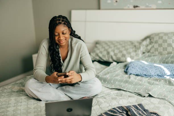 istock Teen sitting in front of computer in her room 2147647794