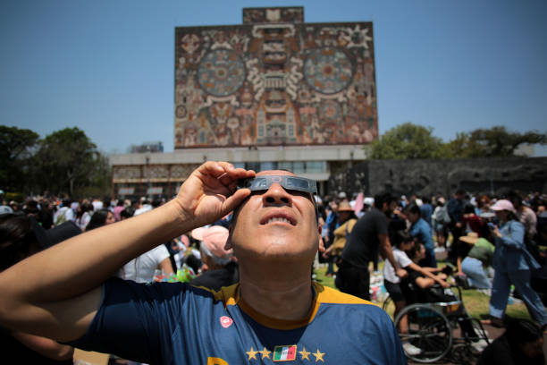 Ciudad de México, México - April 8. 2024: Man with solar eclipse glasses observes the event in National University of Mexico