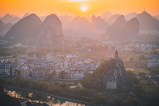 Sunset over the Guilin city surrounded by picturesque limestone mountains. Guilin, China, Copy space for text, aerial
