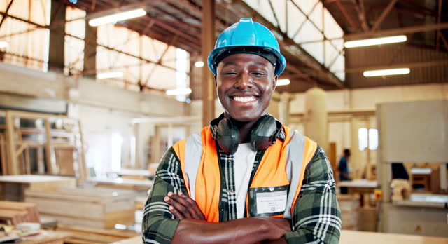 Portrait, black man and architect with smile, headphones and construction, wood and architecture of home. Employee, staff and male person with confidence, happy and helmet for protection in job