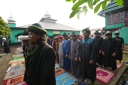 Gowa, Indonesia - April 9 2024: The An Nadzir congregation performs Eid prayers together in neat rows