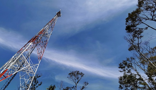 High communication tower at the open sky