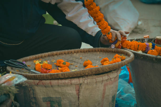 istock A vendor stringing orange marigold flowers into garlands 2147661381