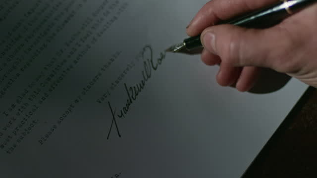 WWII Dramatic Recreation; 1939, President Franklin D Roosevelt signs letter to Albert Einstein